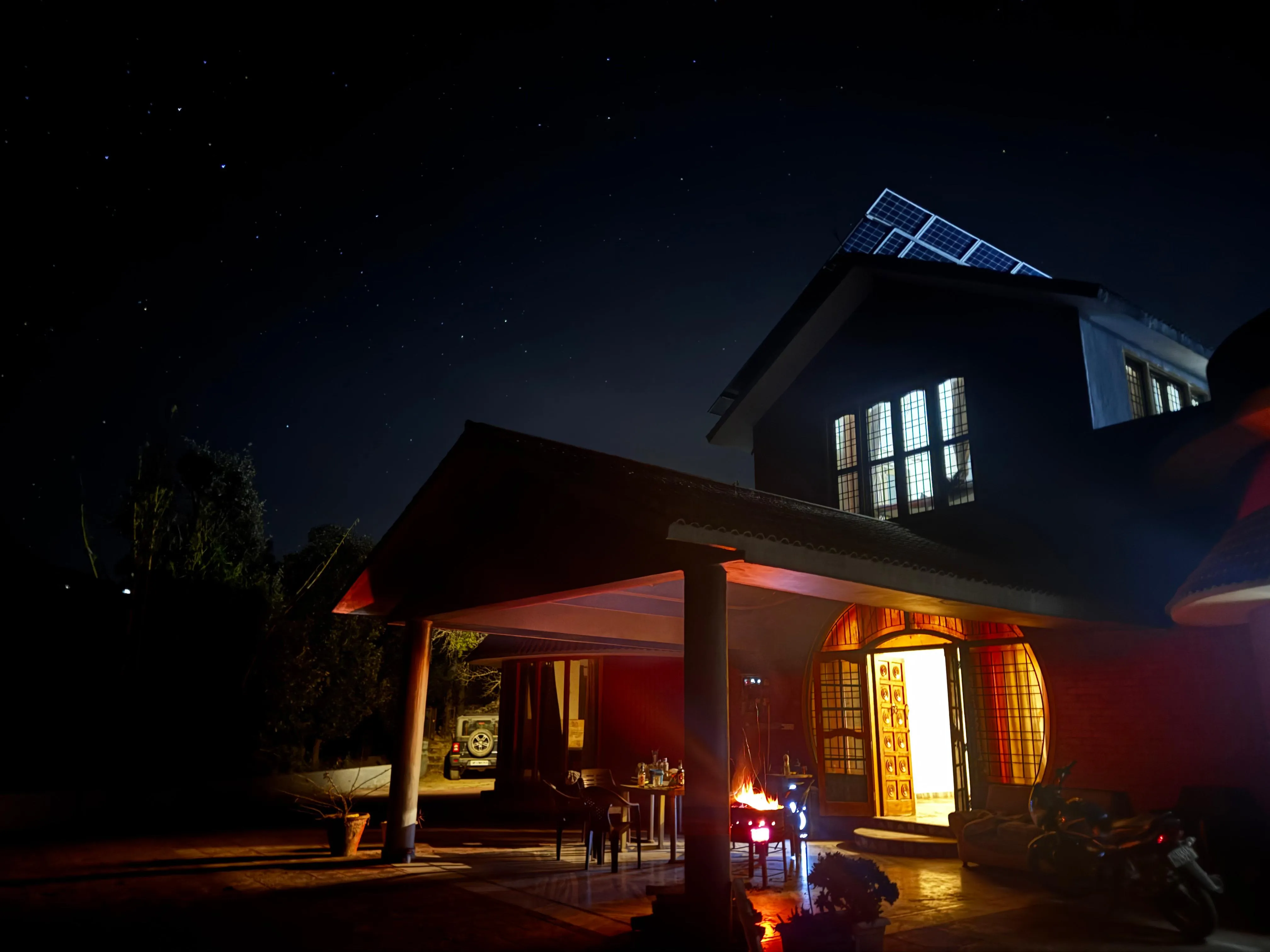 The Yapp Mukteshwar house lit up at night