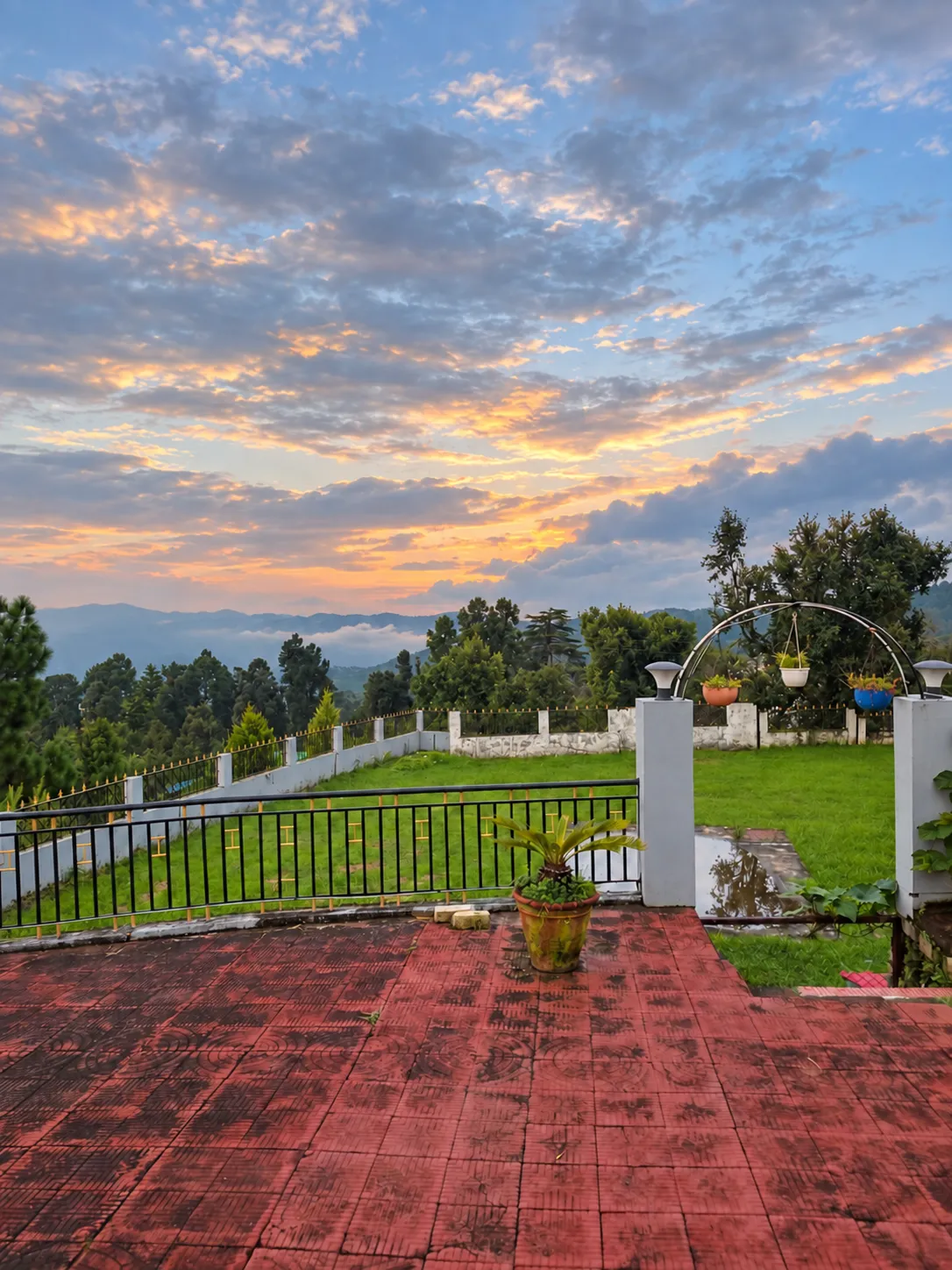 The terrace and lawn of Yapp Mukteshwar at sunset